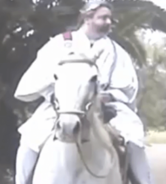 Screenshot 2011 of Raymond E Howard Lear as Lord Rayel Ra EL riding a horse. This photo was taken from a video.